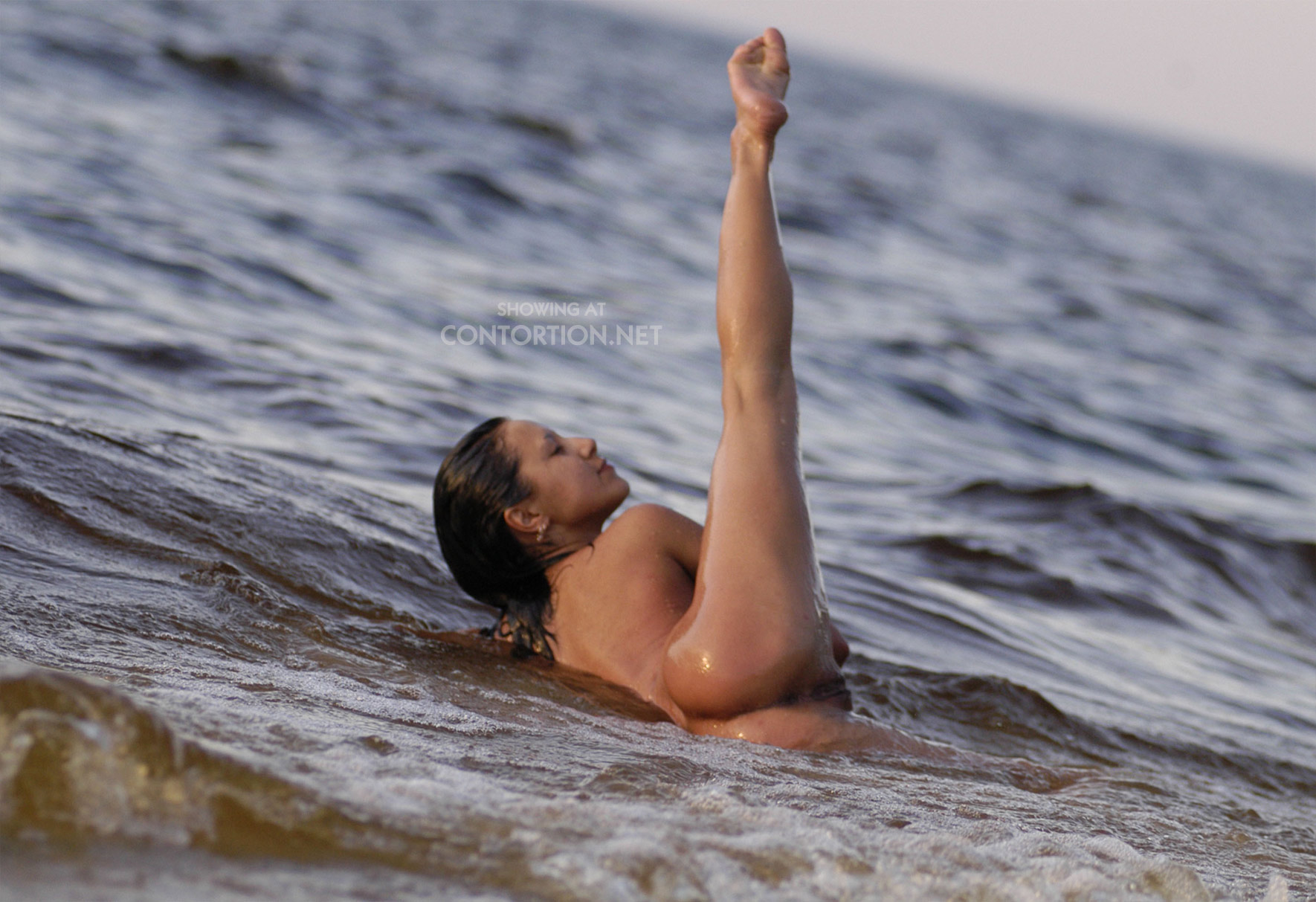 Flexible girl on the sea